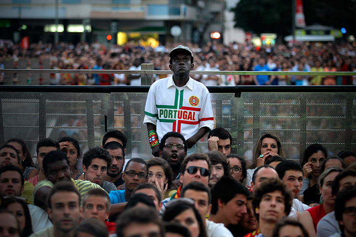 24 hours in pictures: Portuguese fans react while watching the Euro 2012 semifinal