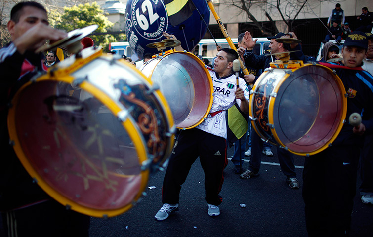 24 hours in pictures: People bang drums as they attend a demonstration at Plaza de Mayo