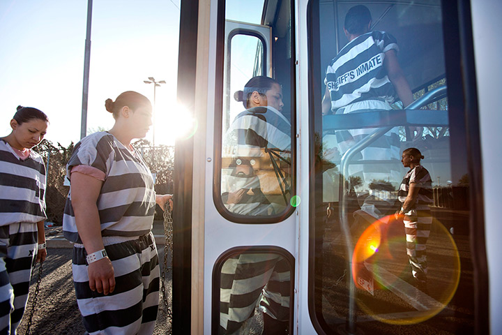 All-female chain gang: All-female chain gang board a bus en route to a highway roadside