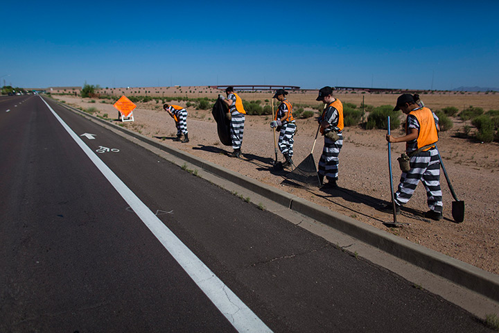 All-female chain gang: Female chain gang pull weeds on a highway roadside