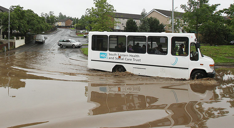 UK Flooding: Lisburn Northern, Ireland: A bus driver drives through flood water