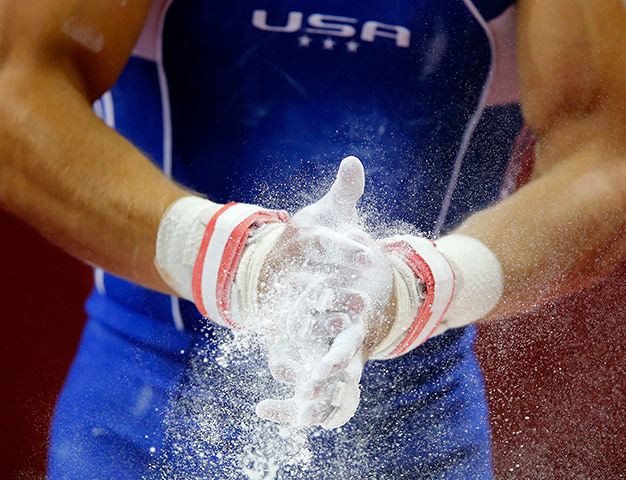 Picture desk live: U.S. gymnast Sam Mikulak applies chalk 