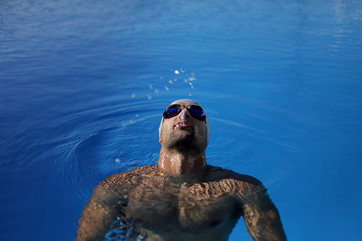 24 hours in pictures: Kareem Innab blows water out of his mouth after finishing his lap