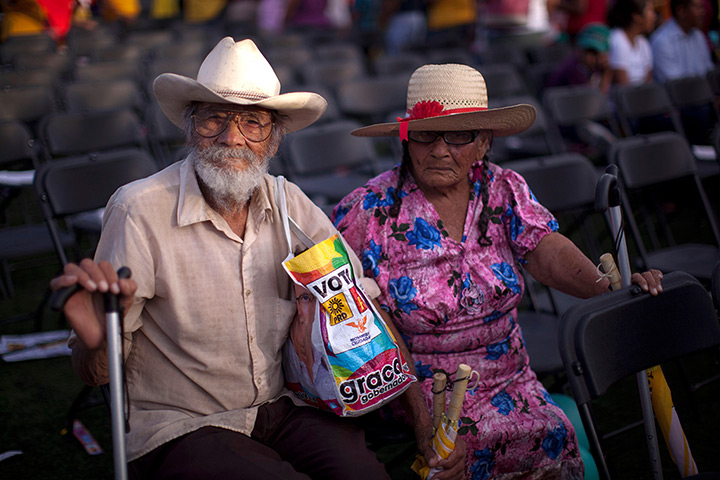 24 hours in pictures: A couple prepare to leave a political rally, Mexico