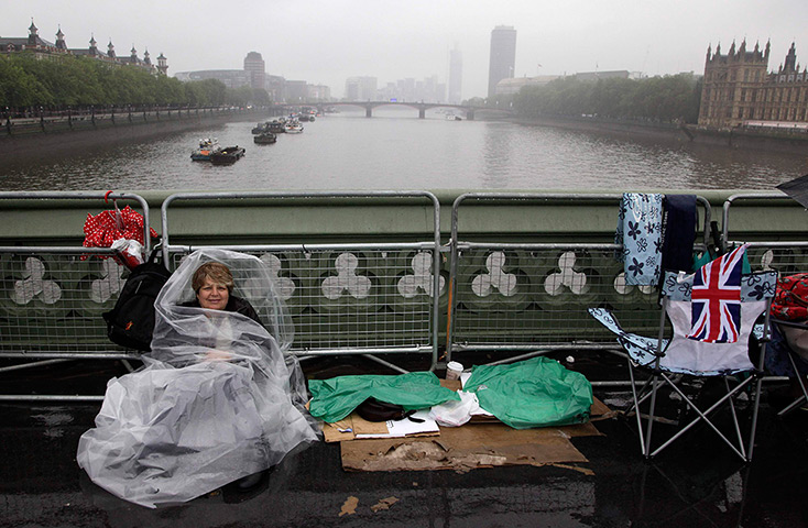 Jubilee pageant: A spectator waits on Westminster Bridge