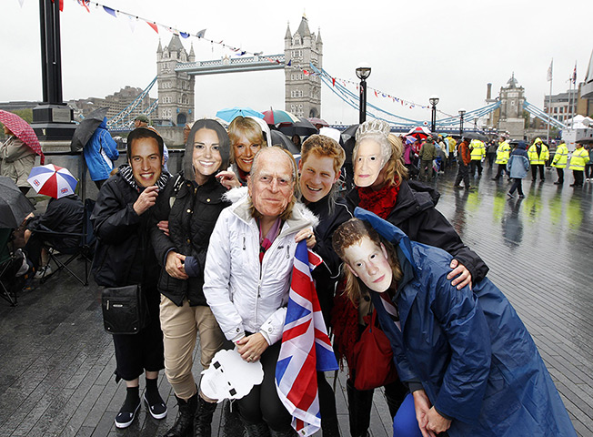Jubilee pageant update: Members of the public wear royal masks near Tower Bridge