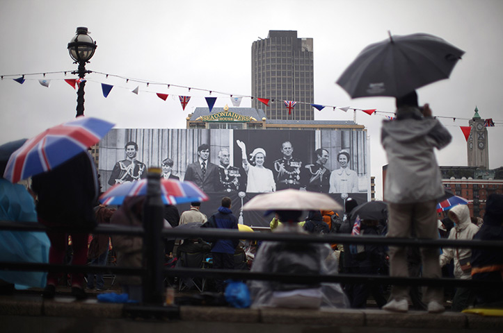 Jubilee pageant update: Revellers Blackfriars Bridge infront of a Royal family banner