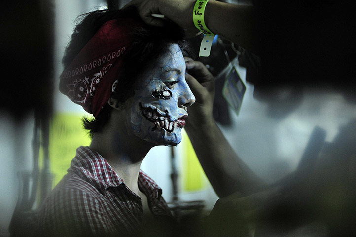 24 hours: Monterrey, Mexico: A woman takes part in a Zombie make-up congress