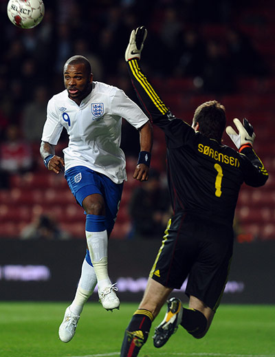 football: England's Darren Bent (L) and Denmark go
