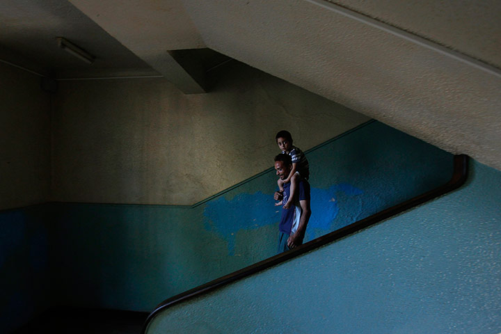 24 Hours: A Roma man carries his child after being rehoused in Baia Mare, Romania