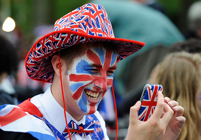 Diamond Jubilee day 2: A Union Jack-themed man checks his mobile phone 