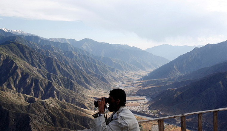 24 hours: Afghanistan: A local commander scans the surrounding terrain 