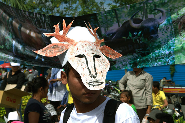 24 hours: Phnom Penh, Cambodia: A Cambodian environmental activist wears a mask 
