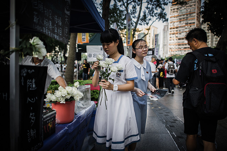 24 hours: Hong Kong, China: A schoolgirl offers roses to commemorate Tiananmen Square