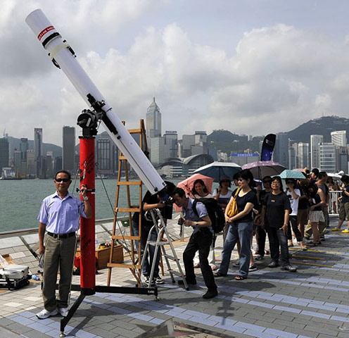 transit: People watch the transit of Venus on the Hong Kong waterfront