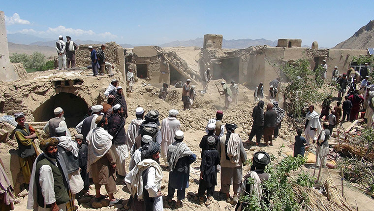 Picture Desk Live: Afghan villagers gather at a house destroyed in an apparent NATO raid