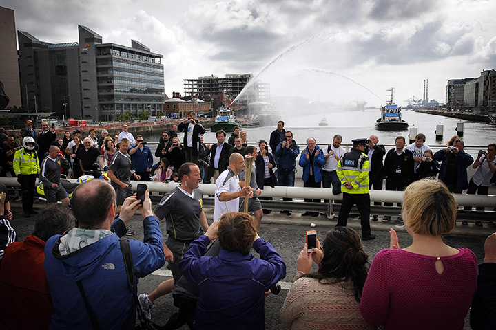 Torch relay day 19: Ex-footballer Paul McGrath carries the torch over  Samuel Beckett Bridge 