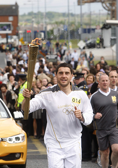 Torch relay day 19: Dublin GAA footballer Bernard Brogan carries the flame in Dublin