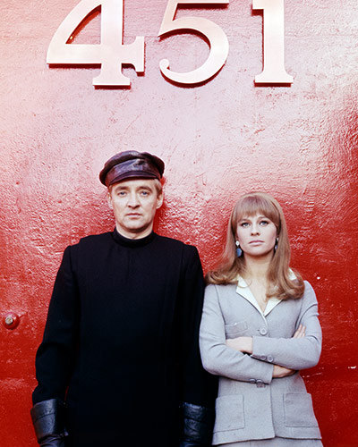 Ray Bradbury: Oskar Werner and Julie Christie, pose beneath a large 451 sign