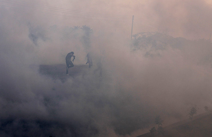 24 Hours: Protesters run through tear gas fired by riot police in Bahrain