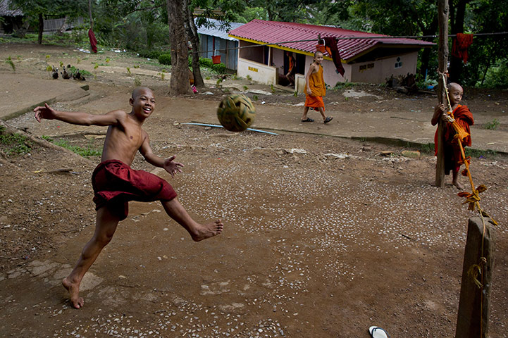 24 Hours: Burmese monks play a game of Sepak Takraw at the Thirisaridar monastery