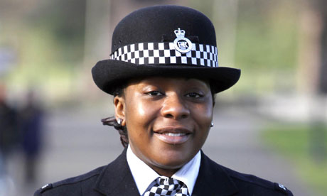 Dominique Walker smiling standing in her police uniform