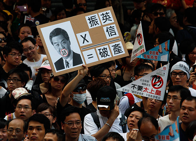 Hong Kong demonstrations: A protester holds a sign mocking new leader Leung Chun-ying
