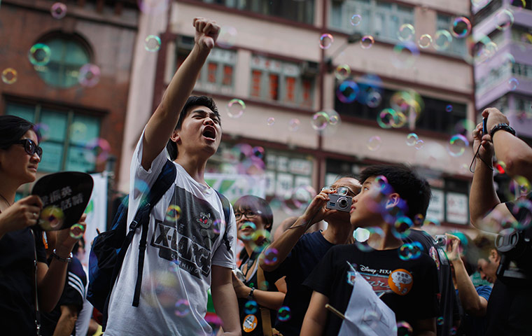 Hong Kong demonstrations: A pro-democracy demonstrator yells slogans as he marches in Hong Kong
