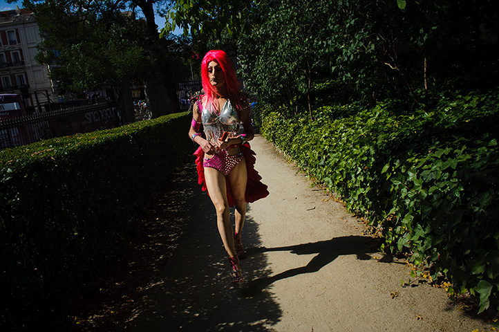 24 hours in pictures: A reveler walks through the Retiro park on his way to Gay Pride