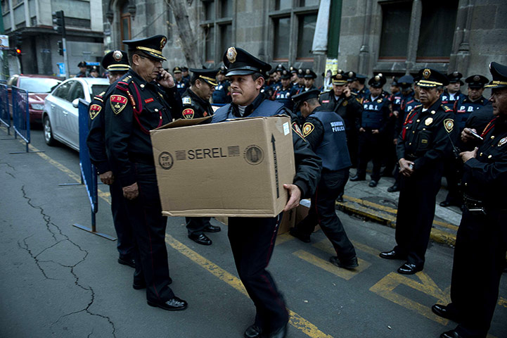 Mexico election: Mexico City: A police officer holds a box with food