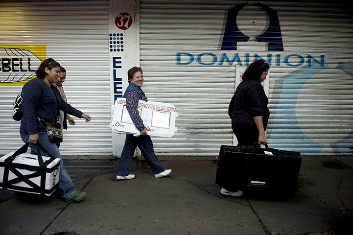 Mexico election: Mexico City: Women carry materials to be used during the election