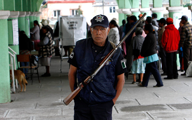 Mexico election: Santiago Xalitzintla, Puebla: A police officer stands guard