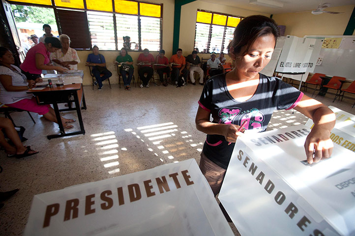Mexico election: Leona Vicario, Cancun: A woman casts her vote at a polling station