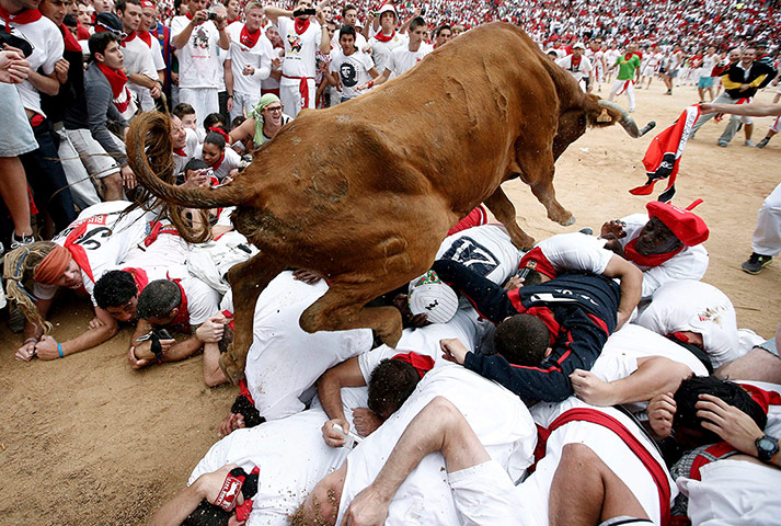 Picture desk live: A bull jumps over several runners at the San Fermin Festival in Spain