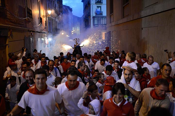 24 hours in pictures: Revellers are showered with sparks at the San Fermin festival