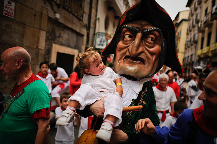 Picture desk live: The big heads parade in Pamplona, Spain
