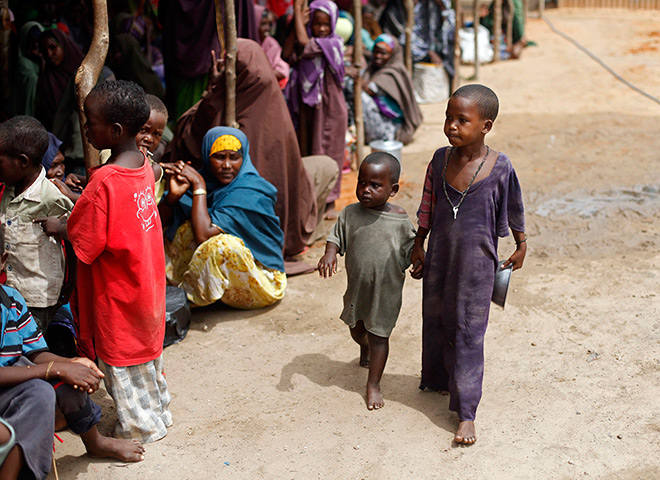 Somalia Goran Tomasevic: Boys arrive at an NGO compound before food distribution in Mogadishu