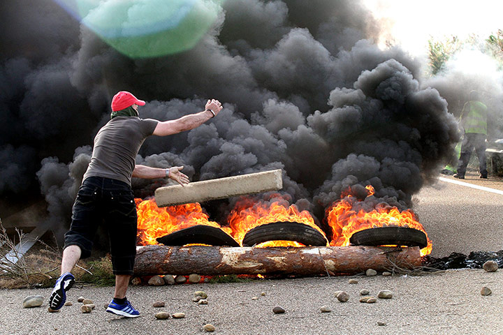 Longer view miners: Miners block the traffic near Palencia, in Castilla-Leon