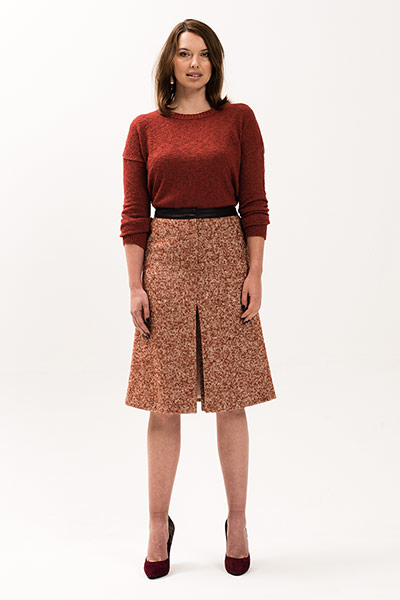 All Ages: Model wears a red jumper and a tweed skirt