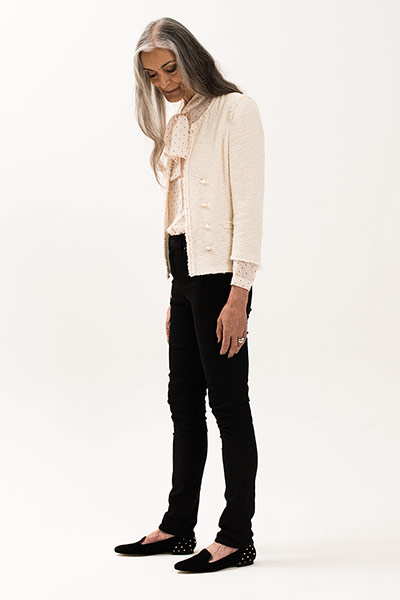 All Ages: Model wears a cream tweed jacket and black trousers