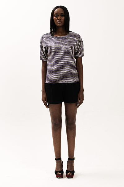 All Ages: Model wears a white and black tweed top