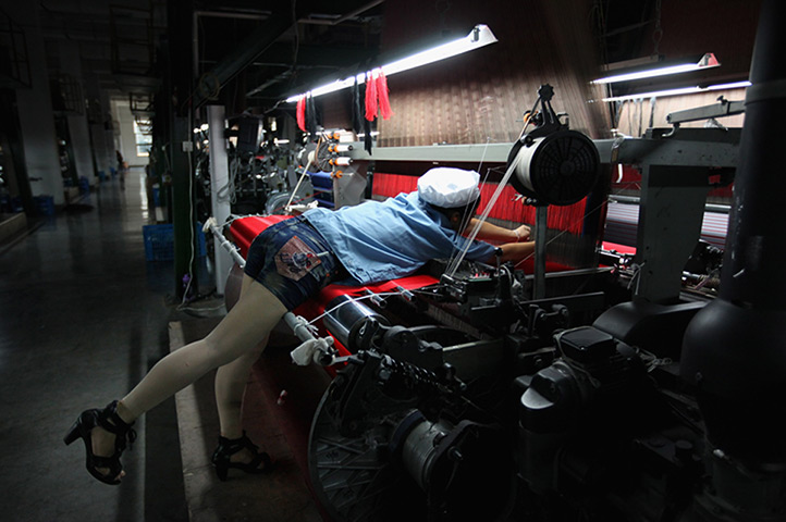 24 hours: Shengzhou, China: A worker controls a textile production line at a factory