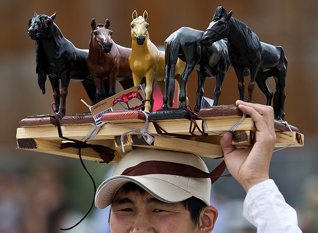 24 hours: Mongolian vendor displays figures of horses for sale