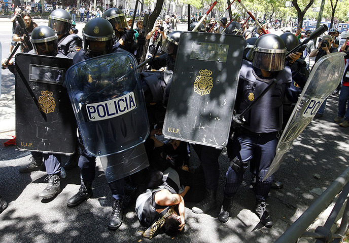 Miners reach Madrid: Riot policemen surround protesters during clashes following a miners' demo
