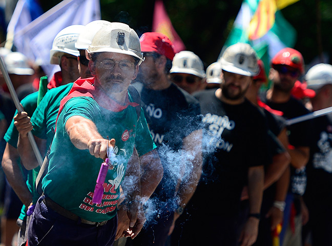 Miners reach Madrid: A Spanish coal miner holds a firecracker