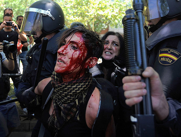 Picture desk live: A woman is arrested by riot police during the Madrid protest by coal miners