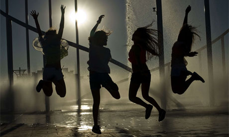Young people cool off in a fountain 