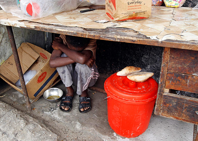 Mogadishu: A boy rests in his street shop in a fishermen port