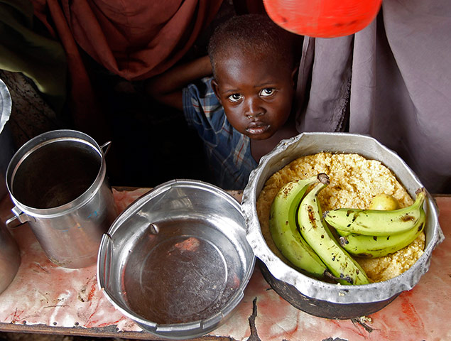 Mogadishu: A boy waits for food during a food distribution 