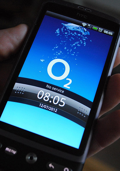 Week in business: A man holds a mobile phone on the O2 network 